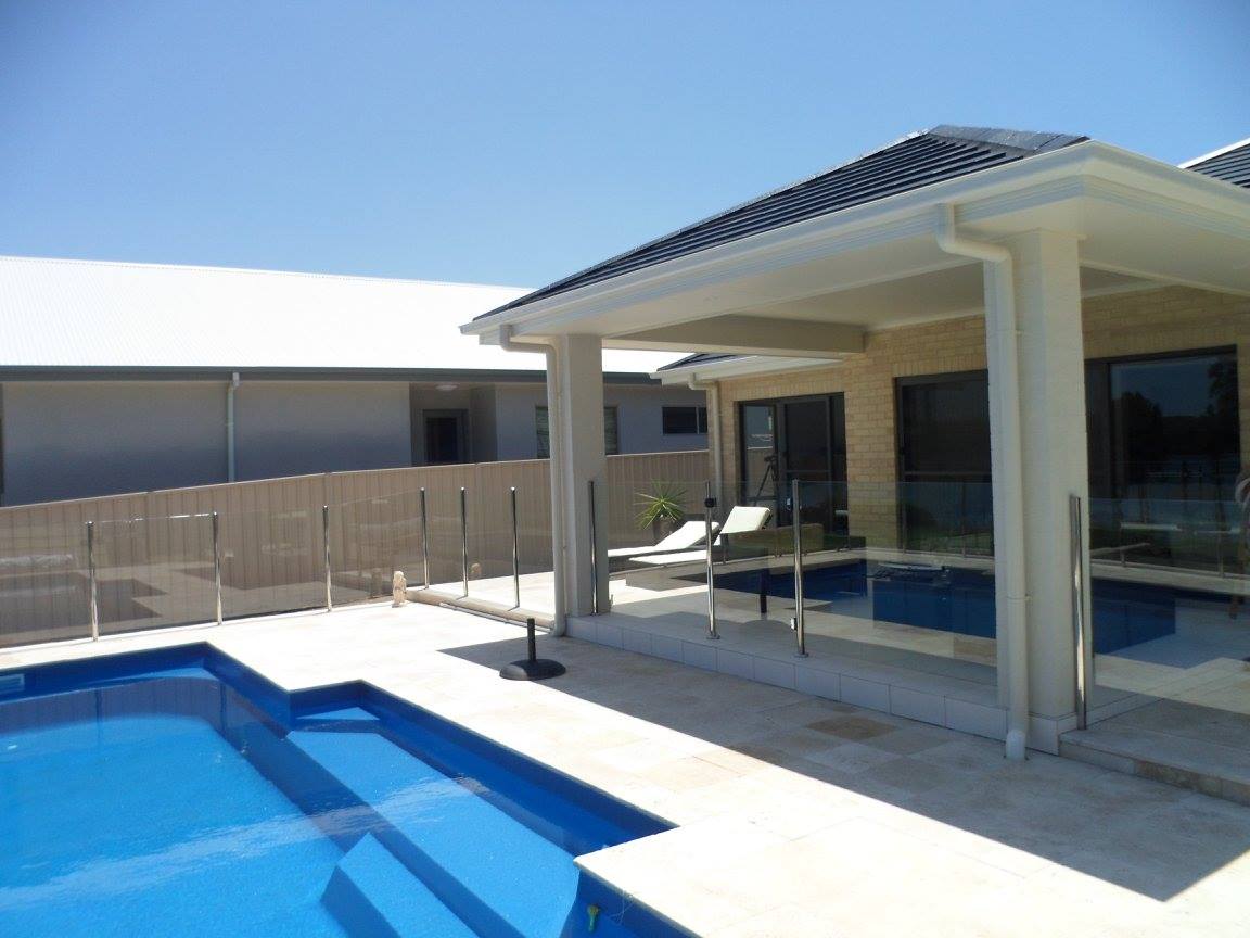 Glass sliding doors and windows on a Shoalhaven home overlooking a pool, glazed by All Hours Glass