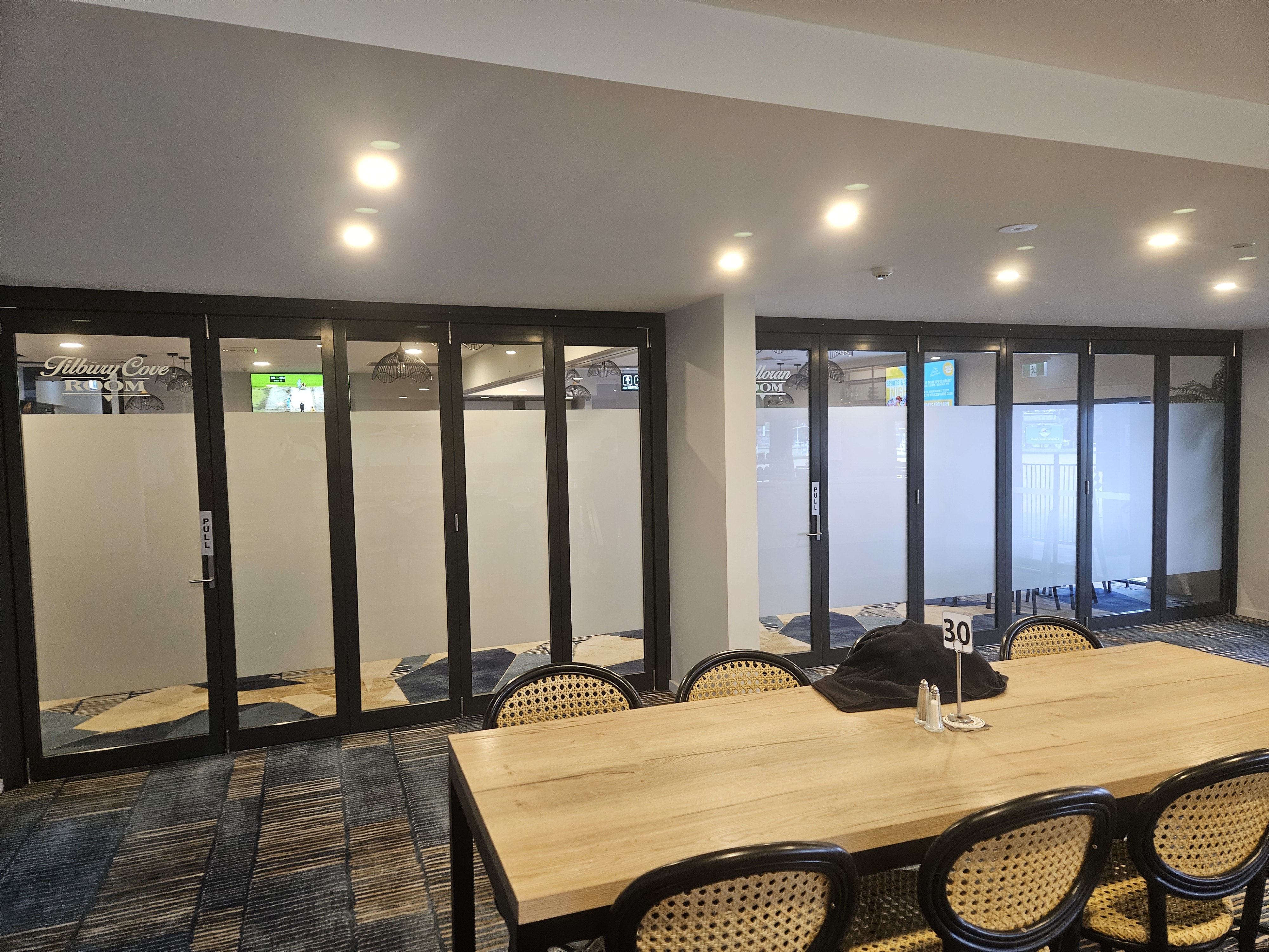 Framed glass partition walls and glass doors installed by All Hours Glass in a Shoalhaven venue