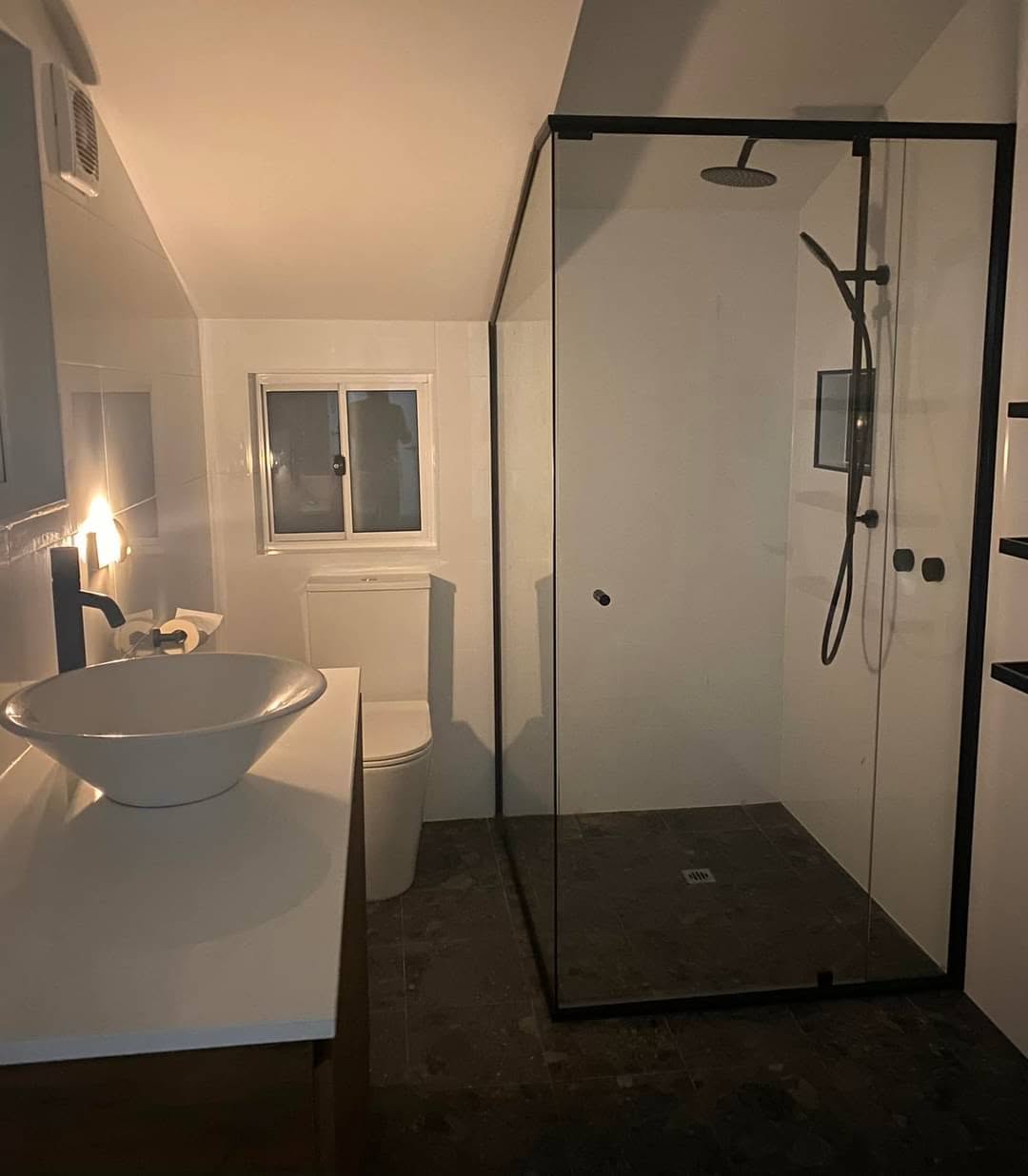 Black-framed glass shower screen installed in a renovated Shoalhaven bathroom