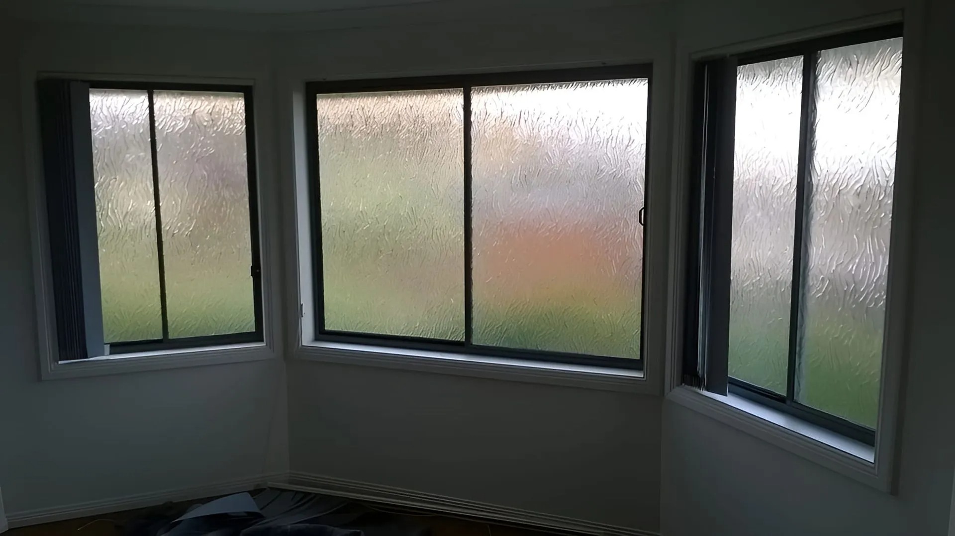Replacement frosted window glazing in a white-framed bay window by All Hours Glass